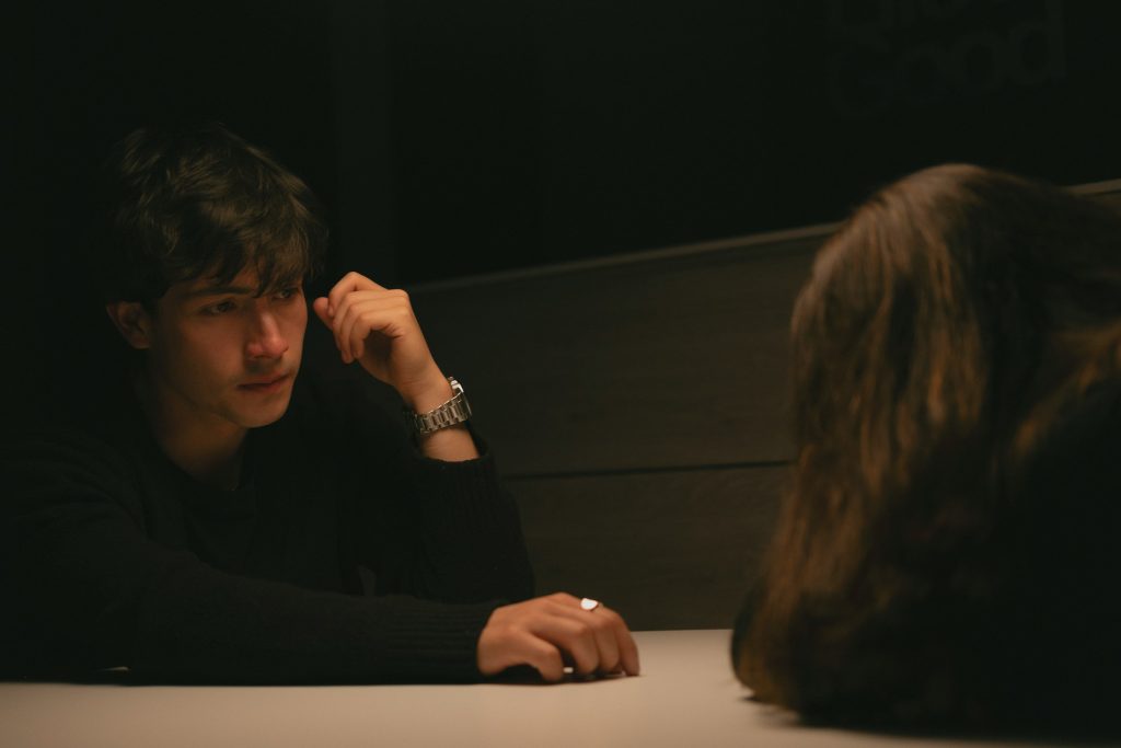 Man reaching out his hand to his partner across the table.