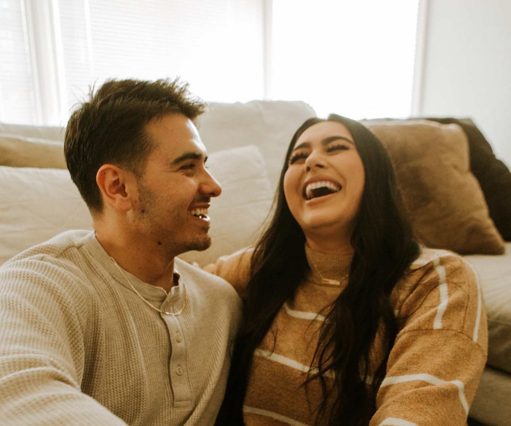 Couple sitting and laughing happily.